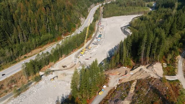 Construction of the TMX oil and gas pipeline in British Columbia Canada. Building an oil pipeline near a river.