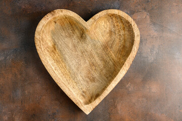 Rustic wooden heart shaped bowl on a rustic background
 - Powered by Adobe