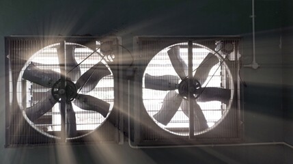 Big industrial Exhaust fan in a factory. Ventilation of plant building. With Shiny light.
