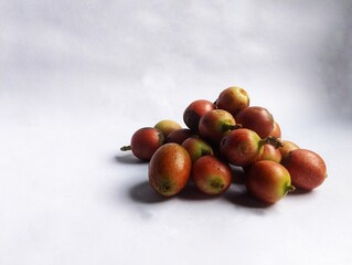 red ripe coffee cherries on a white background