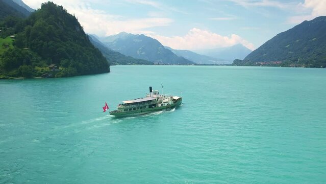 Drone Switzerland 4k. Old steamboat ship tourist boat on lake Thun Brienz in Interlaken. Beautiful Swiss Alps mountains, alpine lake. Switzerland tourism in summer. 