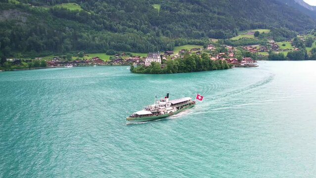 Drone Switzerland 4k. Old steamboat ship excursion boat on Lake Thun Brienz  in Interlaken, Jungfrau region of Swiss Alps. Swiss flag.