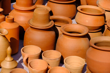 Fototapeta na wymiar Terracotta, pot, cup kitchen souvenirs pile at street handicraft pottery shop. handmade terracotta Products in handicraft market in Pune, India.