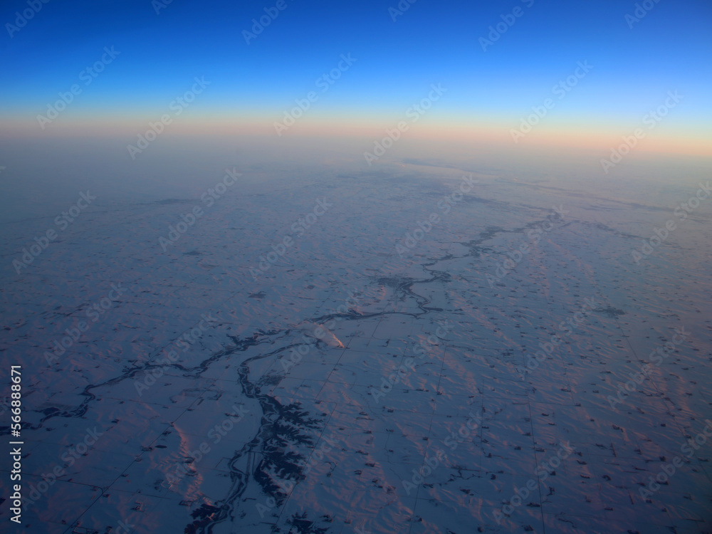 Wall mural river winding through frozen landscape