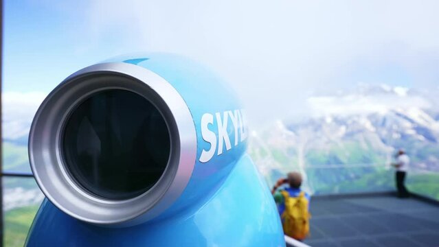 Telescope binoculars at observation deck of Jungfrau mountain. Swiss Alps in summer. Top of Europe, Famous tourism destination in Switzerland. 