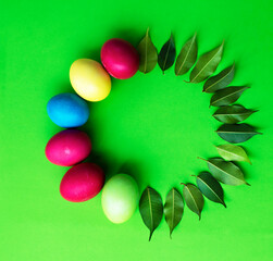 Easter eggs and green leaves. Rosette for text. Card. Congratulation.