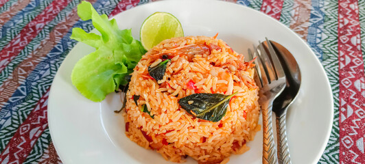 'Tom Yam Kung' Fried Rice,Thai food Mix steamed rice with curry paste With squid and shrimp on the plate