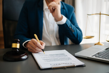 justice and law concept.Male judge in a courtroom on wooden table and Counselor or Male lawyer working in office. .