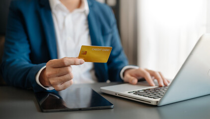 Man using smart phone for mobile payments online shopping,omni channel,sitting on table,virtual icons graphics interface screen