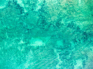 Top view of blue turquoise aqua sea water waves on rocking ocean texture