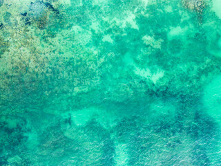 Fototapeta na wymiar Top view of blue turquoise aqua sea water waves on rocking ocean texture