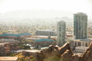 Desert rocks and mountains frame the urban skyline of downtown Tempe, Arizona, USA.