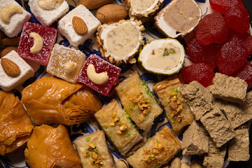 A oriental sweets and nuts on a dark background, close up
