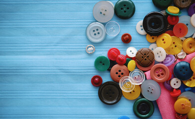 multi-colored buttons on blue fabric. Place for an inscription