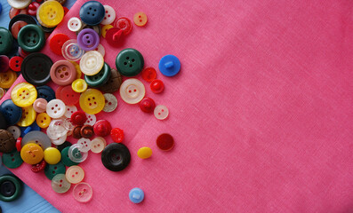 multi-colored buttons on pink fabric. Place for an inscription
