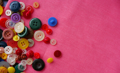 multi-colored buttons on red fabric. Place for an inscription