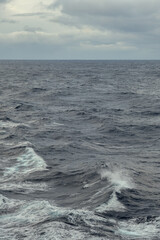 Naklejka na ściany i meble Stormy sea conditions with high swell waves on Atlantic Ocean during transatlantic passage crossing on ocean liner