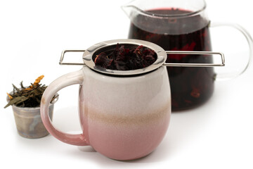 Freshly brewed hibiscus tea with tea infuser