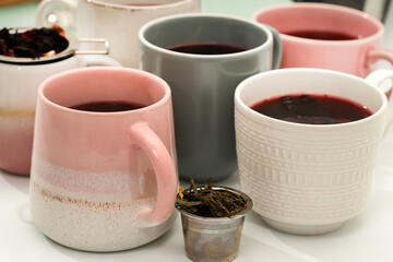 Freshly brewed hibiscus tea with tea infuser