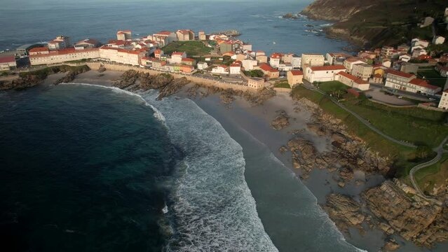 Aerial View Of Ocean Waves On The Beach And Residential Houses In Caion, A Coru&ntilde;a, Spain.