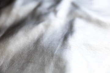 Folds on silver metal  fabric as abstract background