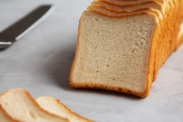 Sliced Whole Wheat White Bread on a gray background, side view. Close-up.