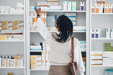 Pharmacy, black woman and pills stock of a customer shopping for medicine, wellness cream or product. Female back, shop and drugs clinic with a person looking for health, medical and shelf products
