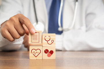 Cardiology specialist treatment. Close-up of hand holding a wooden cube with icons of health
