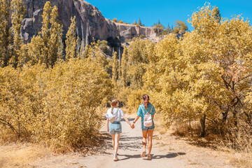 Tourists girls exploring and walking at popular travel attraction of Turkey and Cappadocia - Ihlara valley