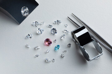 Coloured diamonds of different sizes at the workplace of a diamond expert sorting. High quality...