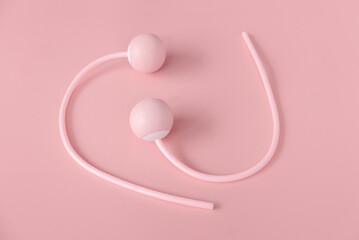 Fitness and healthy sport concept. Pink ropeless jump rope on a pastel pink background.
