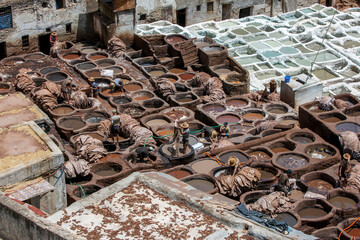 Men working in the chemical pools at the famous Chouara Tannery in the Fez medina in Morocco. The...