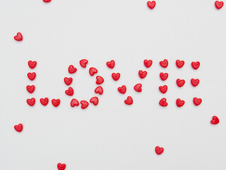 Love word made little red heart on white background for valentine.