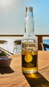 Beer on the table of a terrace and in the background a sunset on the beach