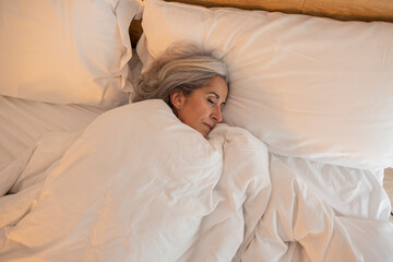 mature woman with gray hair asleep in bed - Beautiful Peaceful Mature Woman Sleeping In Bed - Powered by Adobe