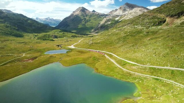 Drone Switzerland 4k. Bernese Oberland by Lake Bianco in Swiss Alps. Rhaetian Railway scenic route to St. Moritz. Switzerland summer tourism.