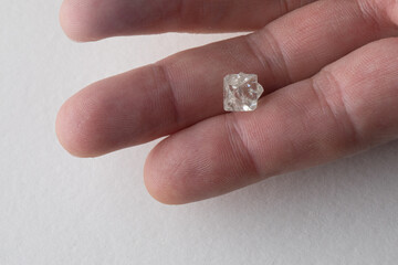 Rough diamond close up in the process of evaluation by diamond expert. High quality photo