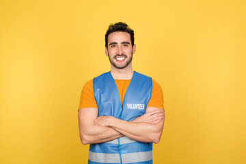 Man in volunteer waistcoat with arms crossed