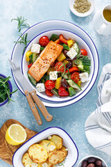 Greek salad with grilled salmon fish. Traditional mediterranean cuisine. Healthy food, diet. Top view