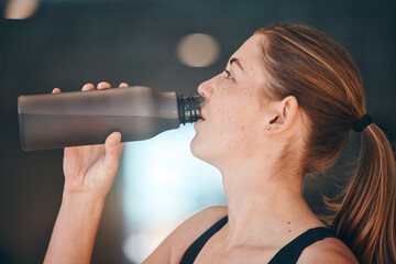 Fitness, break and woman athlete drinking water for thirst, hydration and health in a training studio. Sports, wellness and young female enjoying a healthy cold beverage after a workout or exercise.