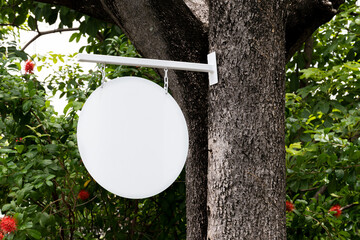 Outdoor white circle sign on tree