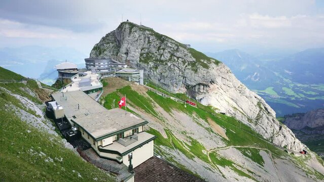 On top of mount Pilatus, funicular railcar train in Swiss Alps, Alpine peak near Lake Lucerne. Switzerland in summer.  
