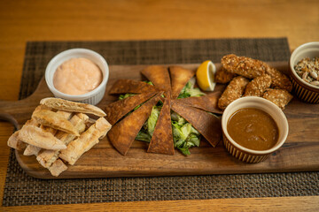 Close up image of served baba ghanoush meal on wooden board.