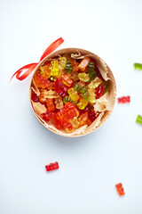 Tasty jelly bears candy in present box on white background, flat lay candy gummy bear, top view, copy space.