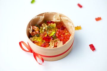 Tasty jelly bears candy in present box on white background, flat lay candy gummy bear, top view, copy space.