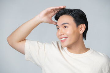 Handsome man touching his hair close up portrait studio on white background