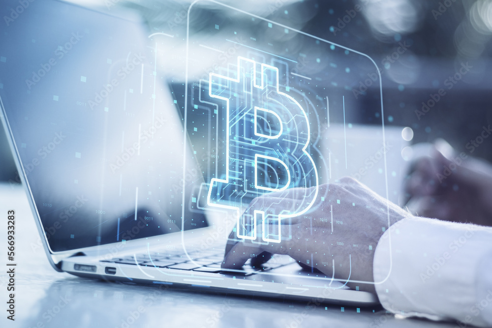 Poster close up of male hands using laptop computer on desktop with coffee cup and glowing bitcoin hologram