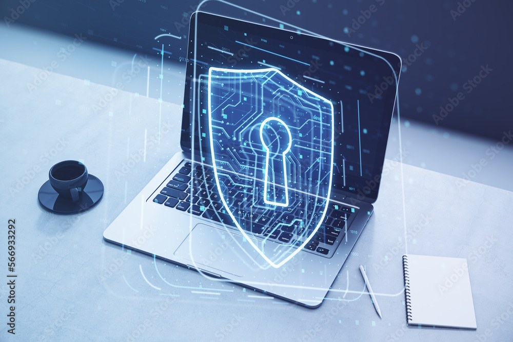Poster close up of laptop on desktop with coffee cup, notepad and glowing padlock hologram on blurry backgr