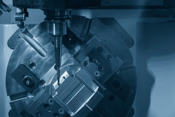 The 5-axis CNC milling machine cutting the automotive parts with ball end mill tool.