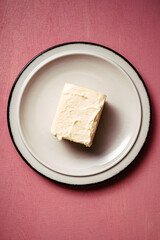 briquette of butter on an appetizing berry background